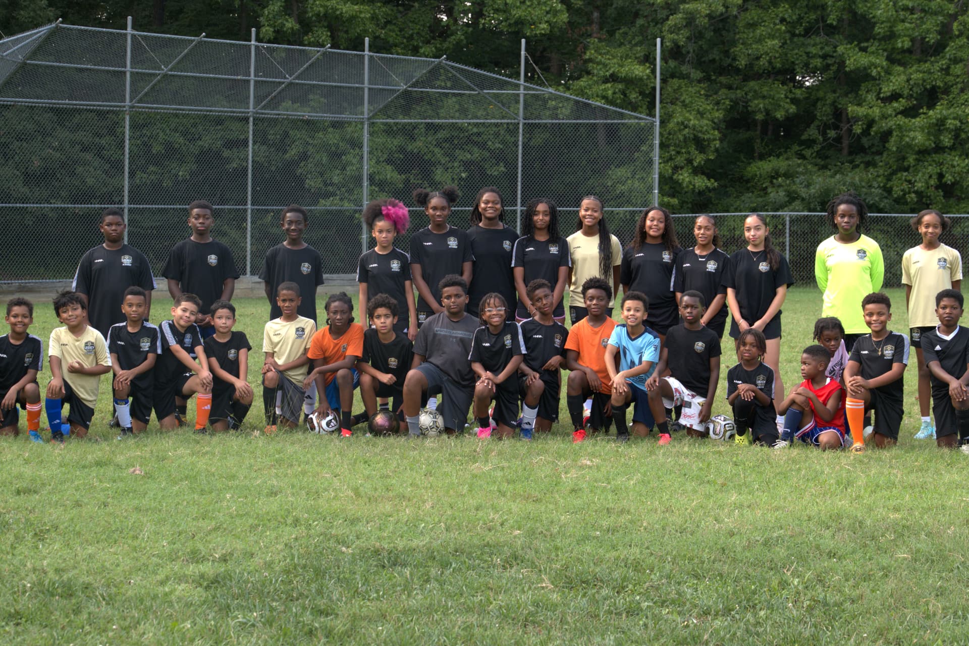 The full Legacy 11 FC Academy squad photographed together on the field