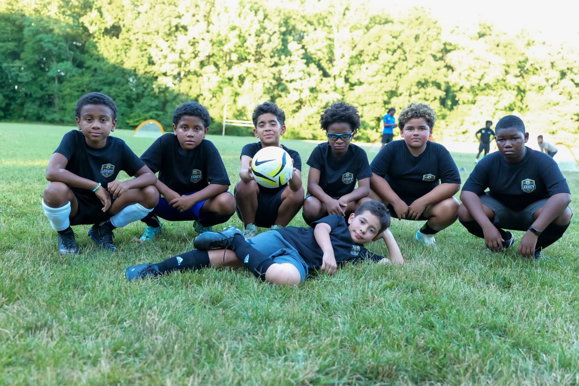 Legacy players in academy training kit posing together after a session