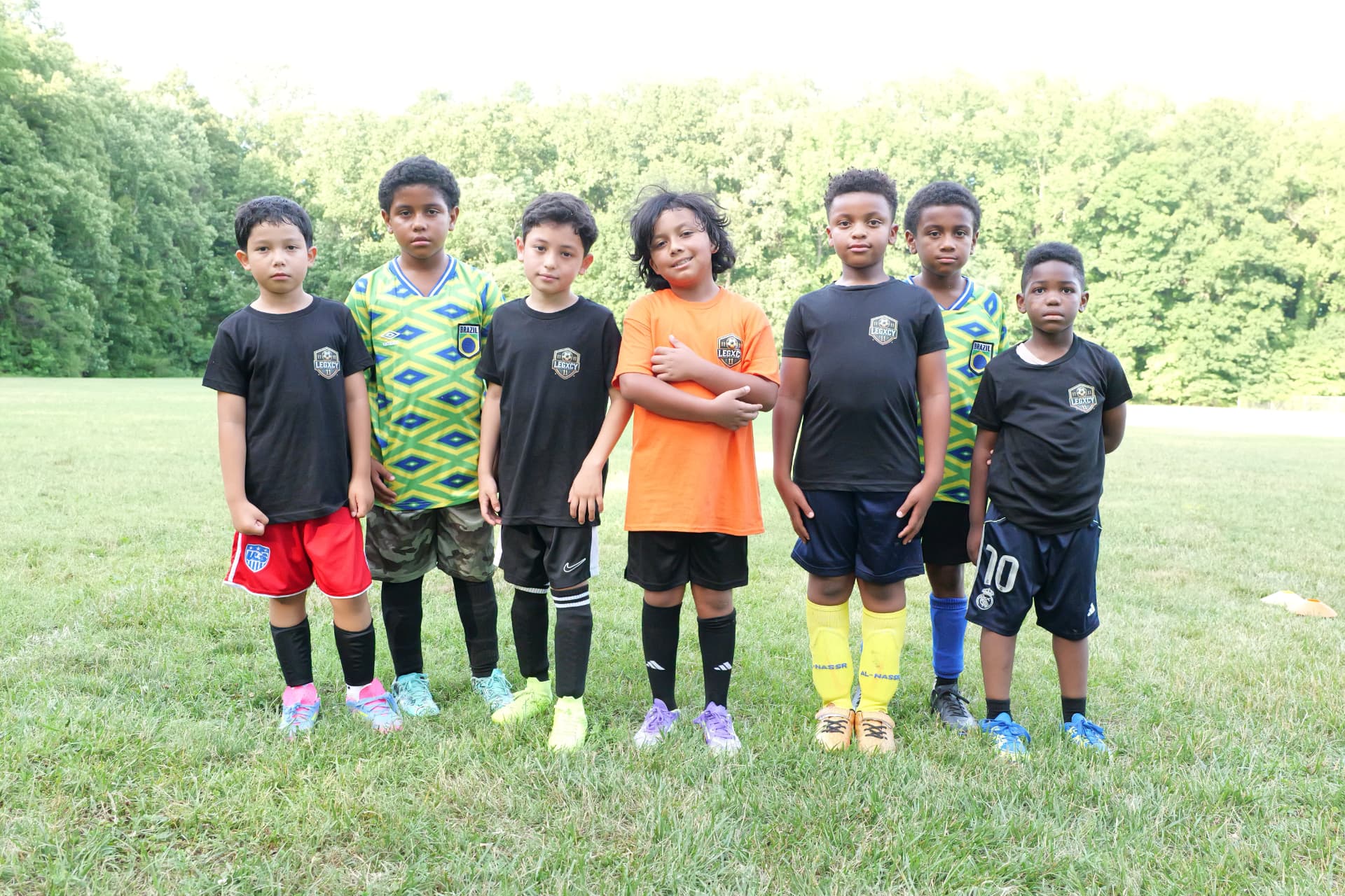 Legacy's youngest players standing together on the field before training