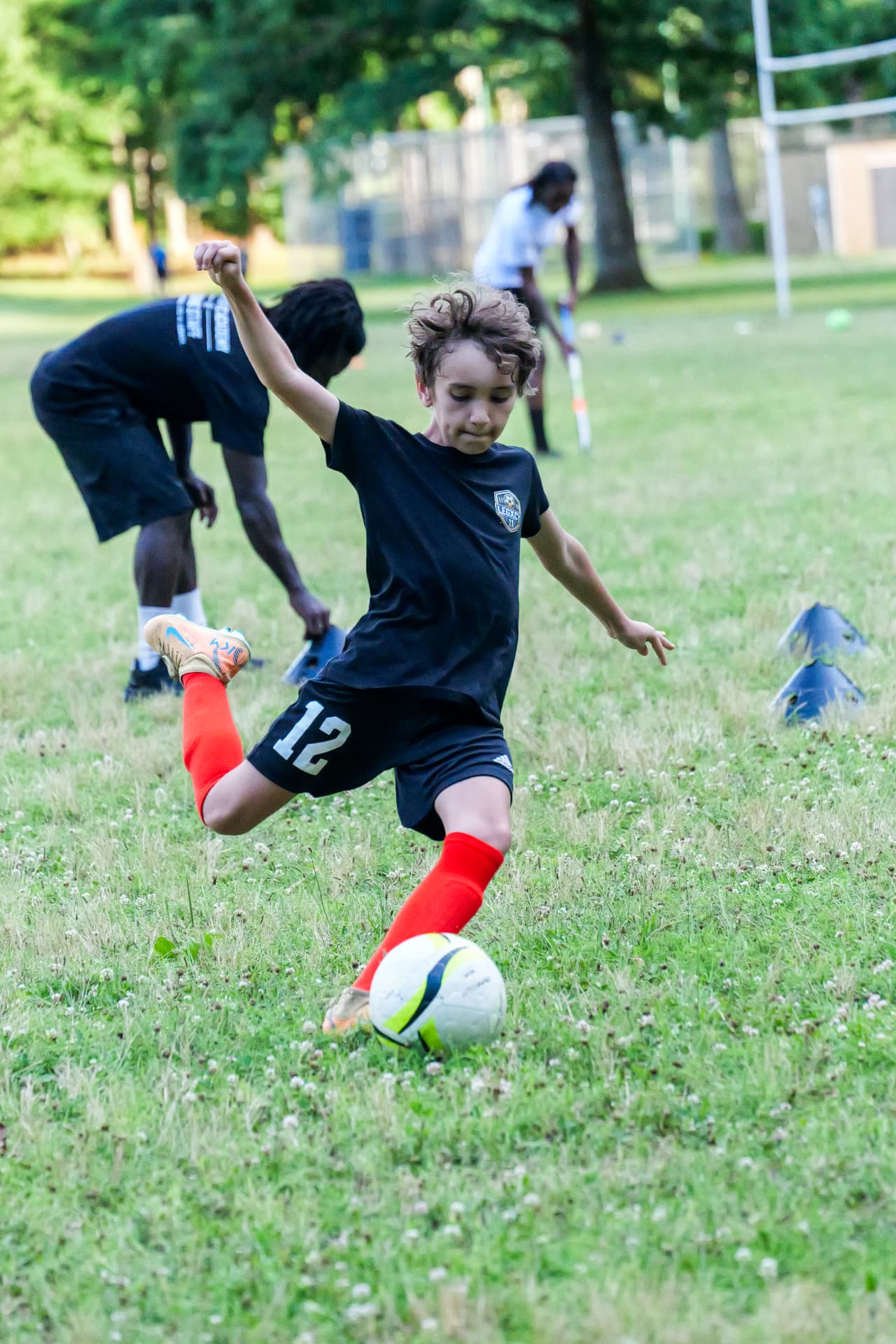 A Legacy player driving onto the ball through a cone channel