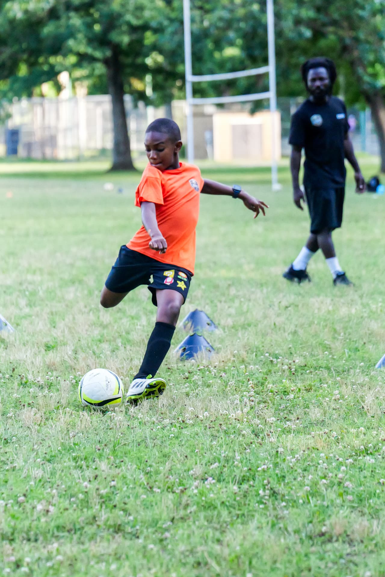 A young Legacy player striking the ball during a training drill