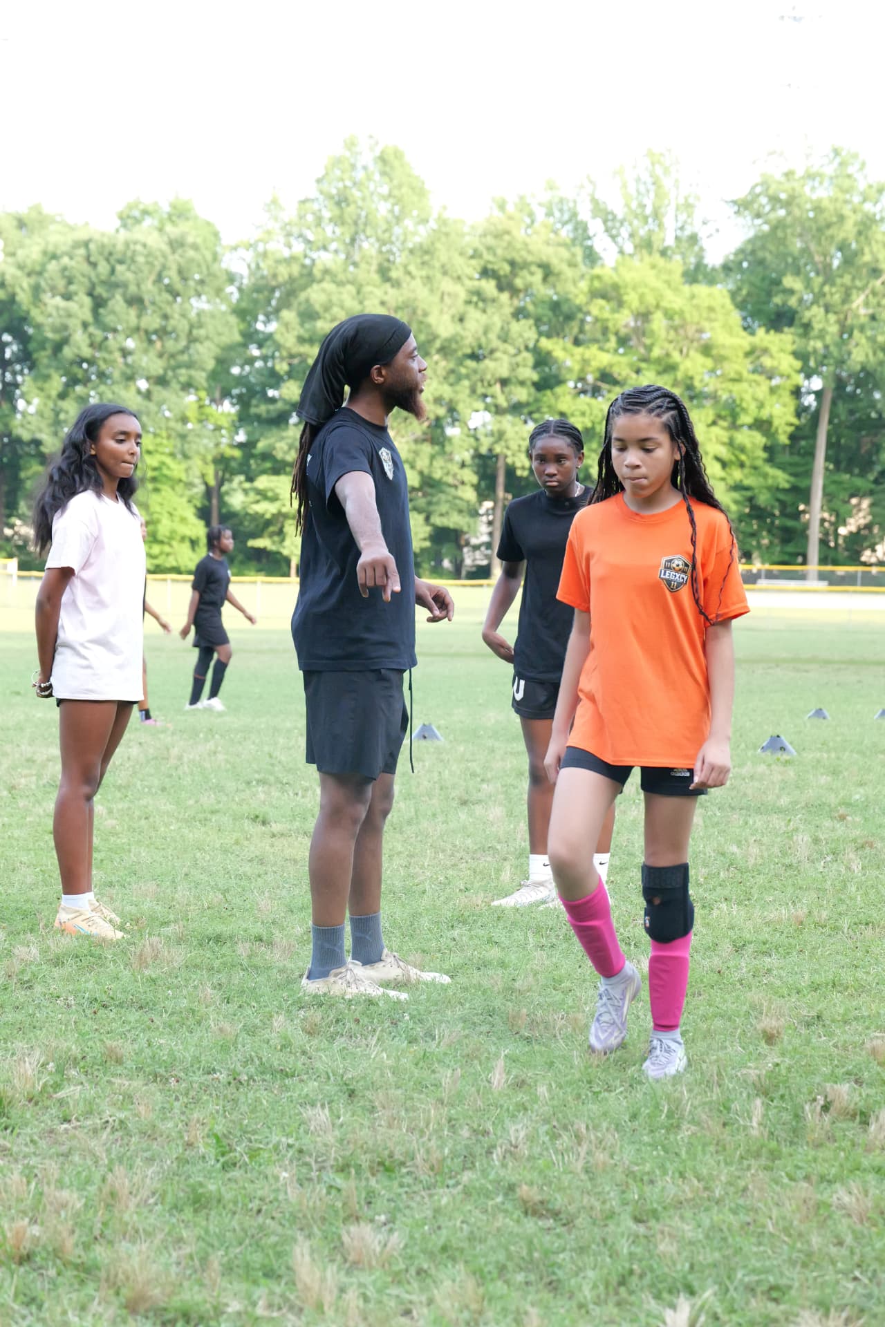 Coach A working with Legacy players during a field session